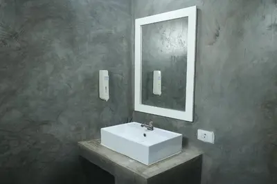 a bathroom with a white sink and a mirror at Burning Flame Patong in Patong Beach