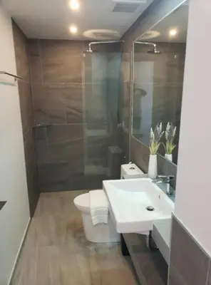 a bathroom with a sink and a toilet and a shower at Chalong Pier apartement in Phuket Town
