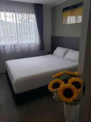 a bedroom with a bed with sunflowers on it at Chalong Pier apartement in Phuket Town