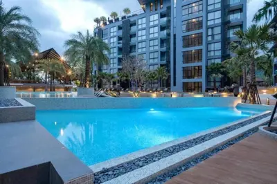 a large blue swimming pool in front of a building at Fully Loaded Resort everything You Need #C142 in Kamala Beach