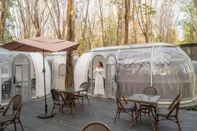 a woman in a white dress standing in a tent at Timber Society Boutique Hideaway in Phuket Town
