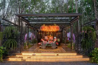 a room with a table with flowers in it at Timber Society Boutique Hideaway in Phuket Town