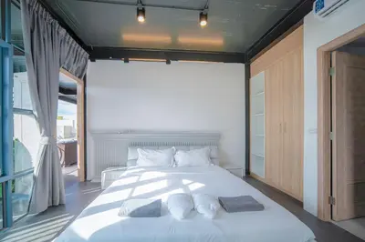 a bedroom with a large bed with towels on it at BangTao 6-bedroom villa 18 meters, competition-grade swimming pool, industrial style design aesthetic, gaming and entertainment floor, suitable for family vacations and group gatherings in Bang Tao Beach