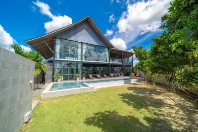 a home with a swimming pool and a house at BangTao 6-bedroom villa 18 meters, competition-grade swimming pool, industrial style design aesthetic, gaming and entertainment floor, suitable for family vacations and group gatherings in Bang Tao Beach