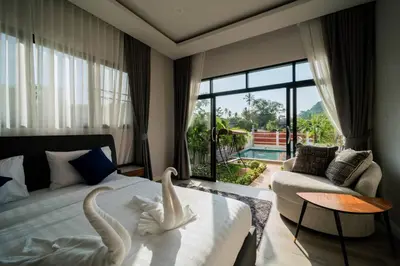 a bedroom with swans made out of towels on a bed at Pool Villa Alawan Krabi Klong Muang R2 in Klong Muang Beach