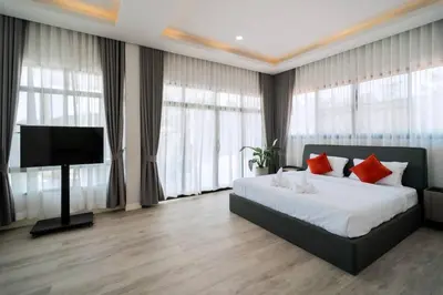 a bedroom with a bed and a flat screen tv at Pool Villa Alawan Krabi Klong Muang R2 in Klong Muang Beach