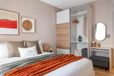 a bedroom with a large bed and a mirror at Title Halo Orange Sunset 46m2 Naiyang Pool&Gym in Nai Yang Beach