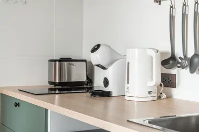 a kitchen counter with a coffee maker and a coffeemaker at Title Halo Orange Sunset 46m2 Naiyang Pool&Gym in Nai Yang Beach