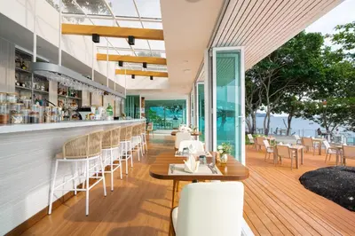 a restaurant with a view of the ocean at Anona Sunset Boutique in Karon Beach