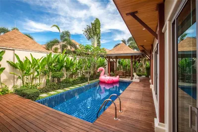 a pool with a pink flamingo in a house at Kokyang Estate by TropicLook in Nai Harn Beach