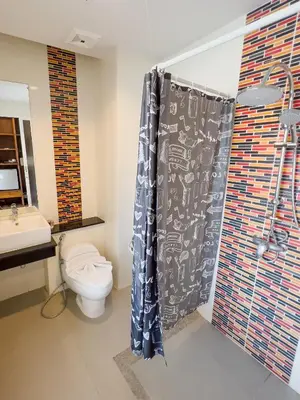 a bathroom with a toilet and a shower curtain at Melissa Kata Beach Resort in Kata Beach