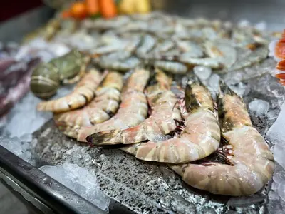a group of shrimp and other seafood on a grill at Melissa Kata Beach Resort in Kata Beach