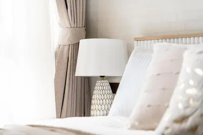 a white bed with a lamp next to a window at Title Halo Modern Line Pool View Gym Sauna in Nai Yang Beach