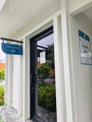 a door to a building with a sign on it at Title Halo Modern Line Pool View Gym Sauna in Nai Yang Beach