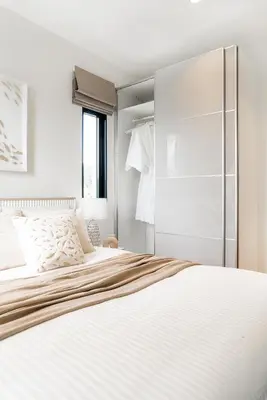 a white bedroom with a large bed and a window at Title Halo Modern Line Pool View Gym Sauna in Nai Yang Beach
