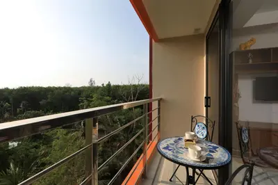 a balcony with a table and a view at Studio 777 Condo MaiKhao in Ban Mai Salae