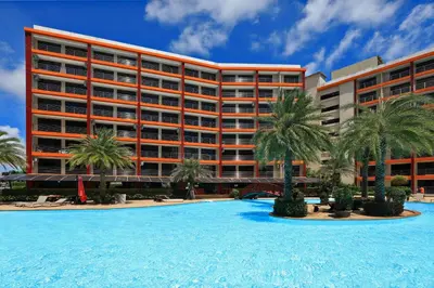 a resort with a large swimming pool and palm trees at Studio 777 Condo MaiKhao in Ban Mai Salae