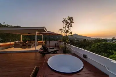a large white plate on a wooden table on a balcony at Great sea View Roof Top V163 in Kamala Beach