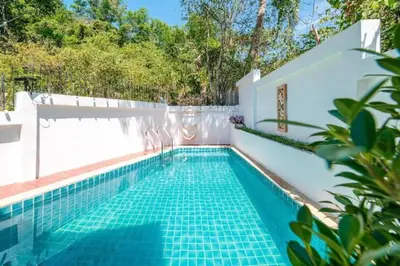 a swimming pool in a house with a white wall at Great sea View Roof Top V163 in Kamala Beach