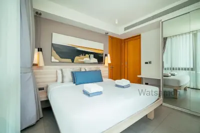 a bedroom with a large white bed in a room at Oceanstone Condo 2 bedrooms BangTao Laguna in Bang Tao Beach
