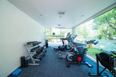 a gym with several treadmills and cardio machines at Oceanstone Condo 2 bedrooms BangTao Laguna in Bang Tao Beach