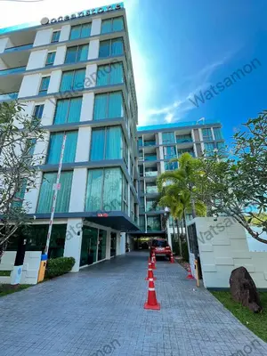 a tall building with orange cones in front of it at Oceanstone Condo 2 bedrooms BangTao Laguna in Bang Tao Beach