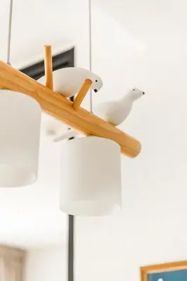 two birds are sitting on a chandelier at Title Halo I Sea You Naiyang Pool Gym Sauna in Nai Yang Beach