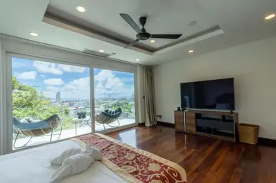 a bedroom with a bed and a large window at Patong 180-degree stunning sea view modern 4-bedroom villa sleeps 10 private pool stunning sunset BBQ in Patong Beach