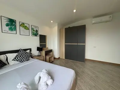 a bedroom with a bed with towels on it at Kamala Evergreen Home in Kamala Beach
