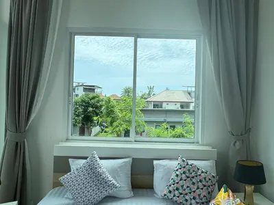 a window in a room with a couch and pillows at Kamala Evergreen Home in Kamala Beach