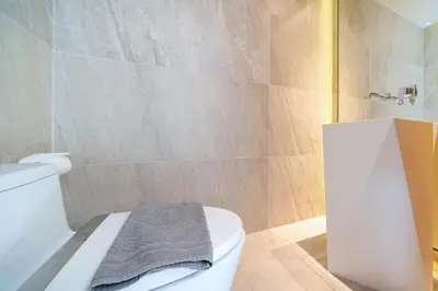 a bathroom with a white toilet and a shower at Ocean Bliss - Sapphire Bay 3BR Apartment 812 with Terrace and Awe-Inspiring Views of Patong Bay in Patong Beach