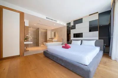 a bedroom with a large white bed and a bathroom at Ocean Bliss - Sapphire Bay 3BR Apartment 812 with Terrace and Awe-Inspiring Views of Patong Bay in Patong Beach