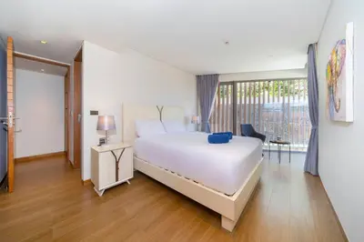 a bedroom with a white bed and a large window at Luxury Ocean View 2BR Apartment 82 in Sapphire Bay Residence, near Patong and Paradise Beach in Patong Beach