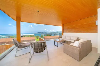 a living room with a view of the ocean at Luxury Ocean View 2BR Apartment 82 in Sapphire Bay Residence, near Patong and Paradise Beach in Patong Beach