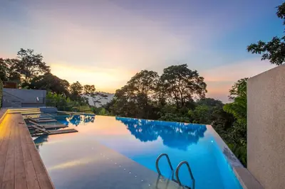 a swimming pool with a view of the sunset at Luxury Ocean View 2BR Apartment 82 in Sapphire Bay Residence, near Patong and Paradise Beach in Patong Beach