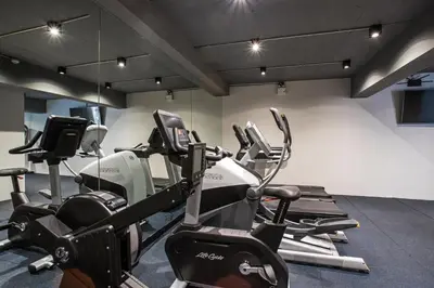 a gym with several cardio machines in a room at Luxury Ocean View 2BR Apartment 82 in Sapphire Bay Residence, near Patong and Paradise Beach in Patong Beach