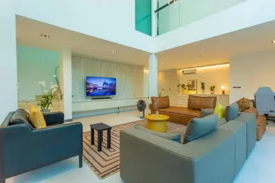 a living room with two couches and a flat screen tv at Nicest In Phuket 4Br 1 km Bang Tao Beach V141 in Bang Tao Beach