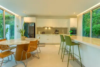 a kitchen with a table and chairs and a counter at Nicest In Phuket 4Br 1 km Bang Tao Beach V141 in Bang Tao Beach