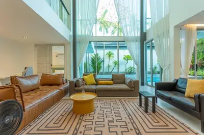 a living room with two couches and a table at Nicest In Phuket 4Br 1 km Bang Tao Beach V141 in Bang Tao Beach