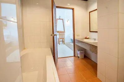 a bathroom with a tub and a sink at The BRC Ao-nang Hotel in Ao Nang Beach