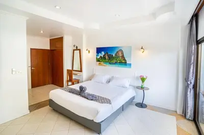 a bedroom with a large bed in a room at The BRC Ao-nang Hotel in Ao Nang Beach