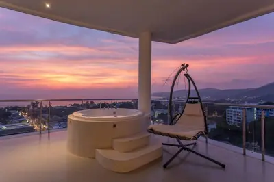 a bathroom with a tub and a chair on a balcony at Best View In Phuket! 2 Living Rooms 4 BR #C80 in Karon Beach