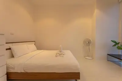 a bedroom with a bed and a fan at Best View In Phuket! 2 Living Rooms 4 BR #C80 in Karon Beach