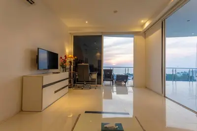 a living room with a television and a table with chairs at Best View In Phuket! 2 Living Rooms 4 BR #C80 in Karon Beach