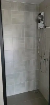 a bathroom with a shower with a shower head at Centrally located new and affordable condo for the first mover in Ban Ket Ho