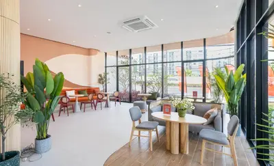 a lobby with a table and chairs and a piano at Centrally located new and affordable condo for the first mover in Ban Ket Ho