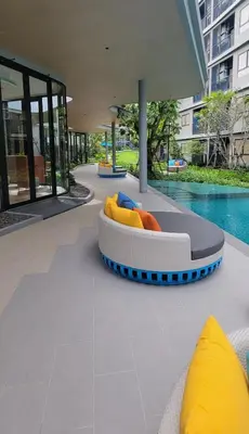 a room with a bed on the floor next to a pool at Centrally located new and affordable condo for the first mover in Ban Ket Ho