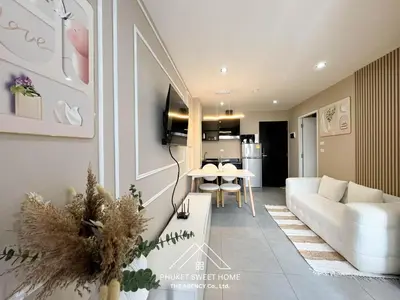 a living room with a white couch and a table at Tower condo Rawai Phuket 305 in Ban Klang