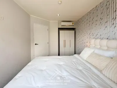 a bedroom with a large white bed in it at Tower condo Rawai Phuket 305 in Ban Klang