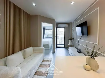 a living room with a white couch and a tv at Tower condo Rawai Phuket 305 in Ban Klang